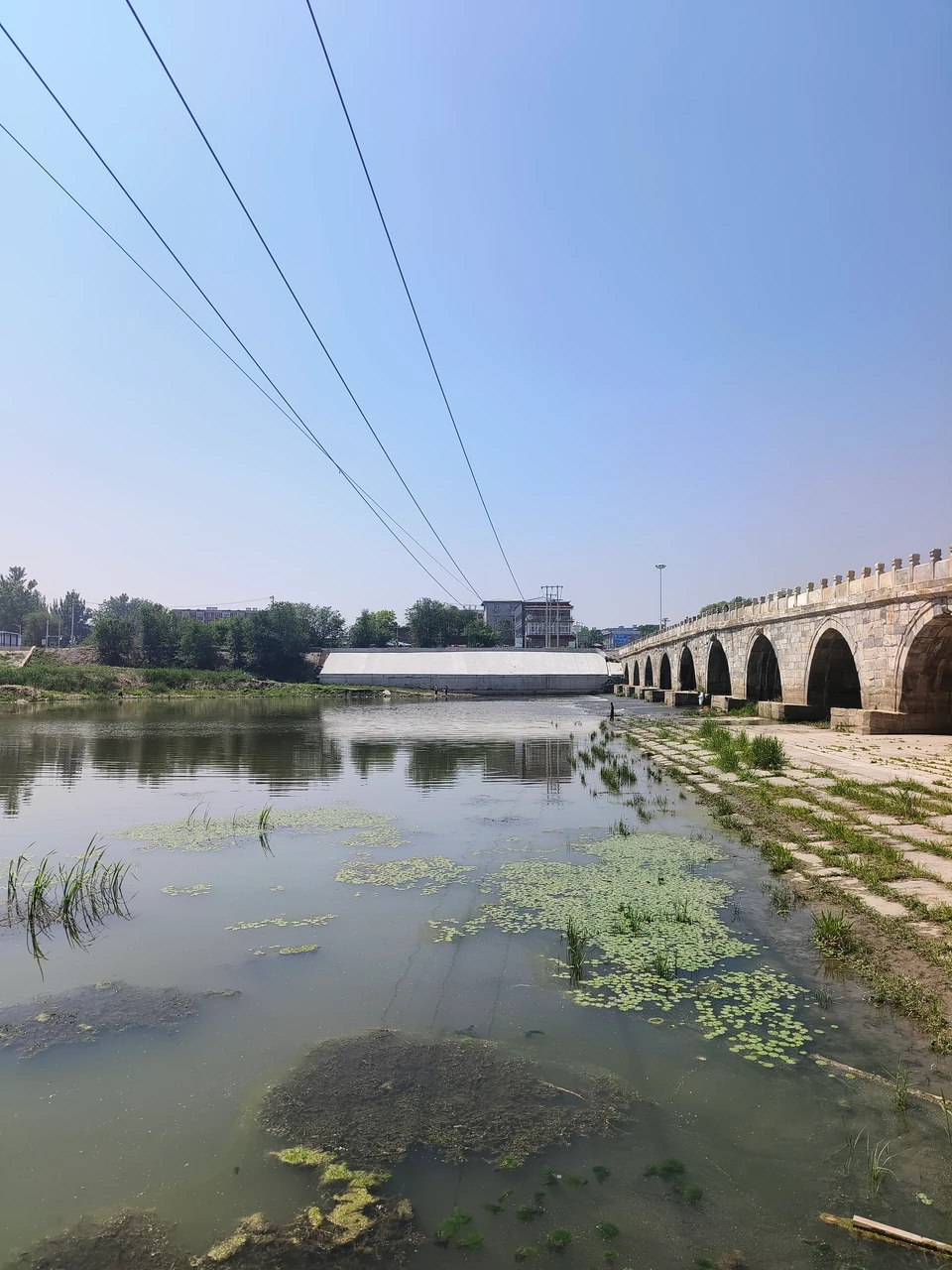 Liulihe stone bridge, river water, and aquatic plants