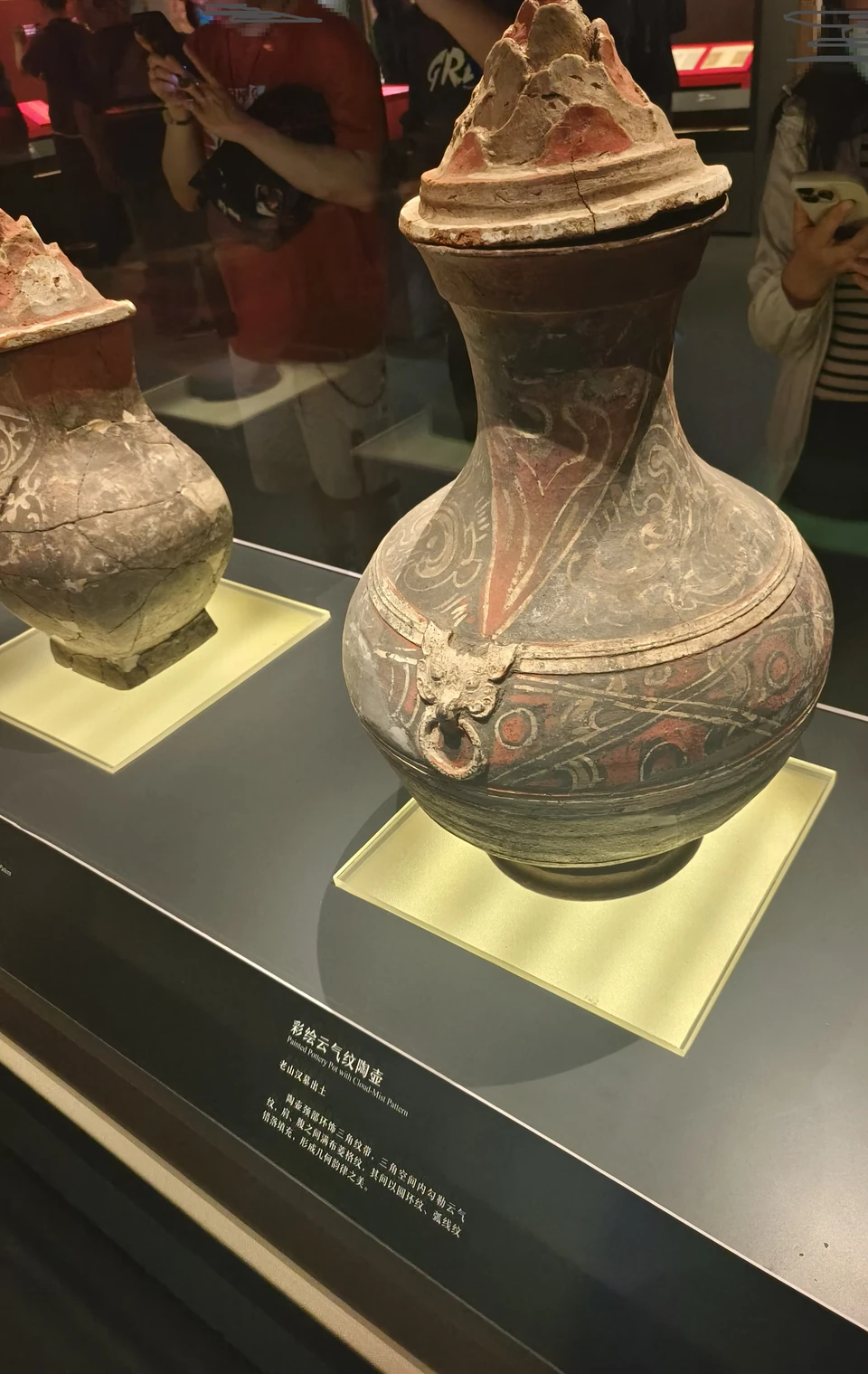 Pottery jar with a mountain-shaped lid and painted decoration